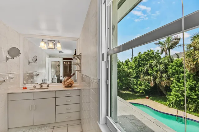 a bathroom with a sink mirror and vanity