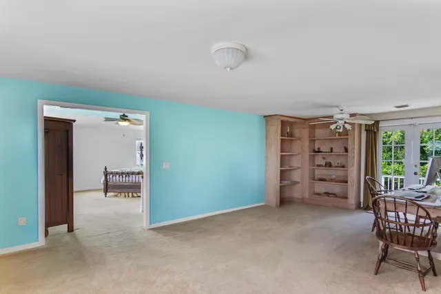 a view of a bedroom with furniture and window