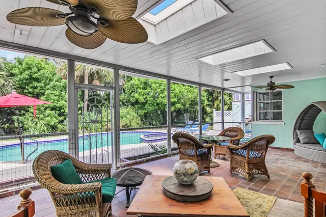 a view of a dining room with furniture wooden floor and a floor to ceiling window