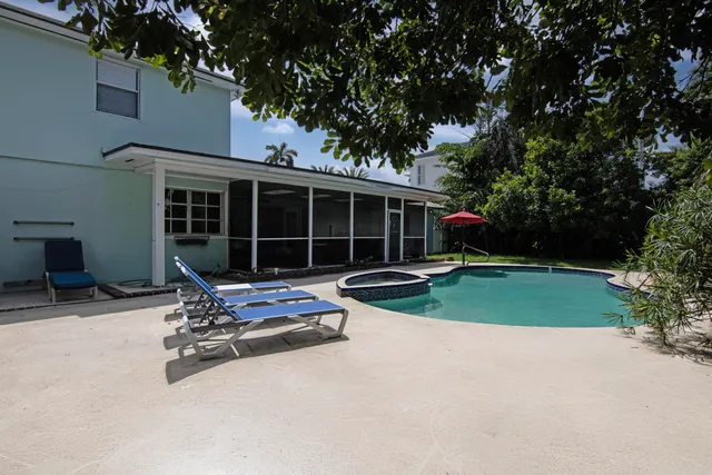 a wooden bench sitting in front of a house