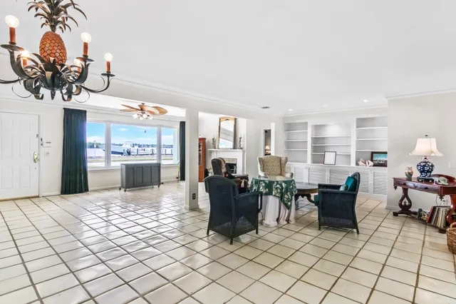 a living room with furniture a chandelier and a dining table