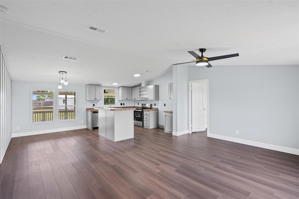 430 Indian Hills Road Bowie, TX 76230 - Photo 4 of 36 a view of a kitchen with stove and wooden floor