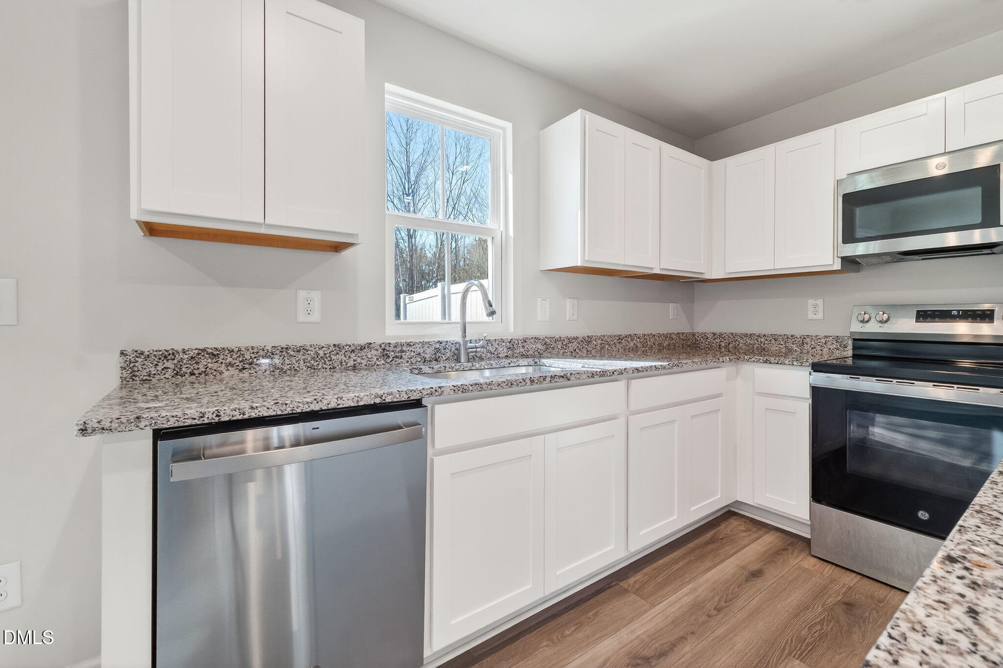 6684 Gibraltar Rock Drive Raleigh, NC 27610 - Photo 11 of 33 a kitchen with granite countertop cabinets stainless steel appliances a sink and a window