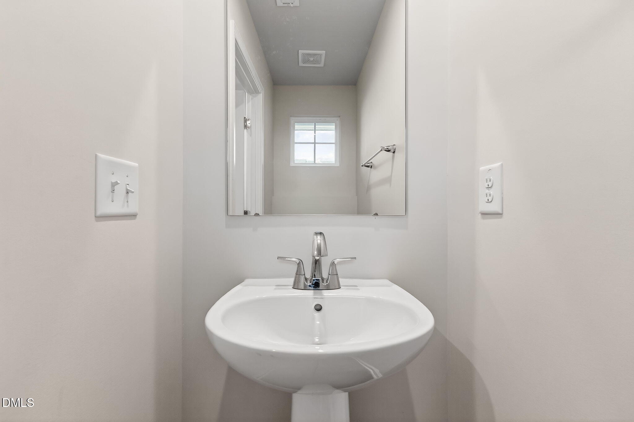6684 Gibraltar Rock Drive Raleigh, NC 27610 - Photo 29 of 33 a bathroom with a sink and a mirror