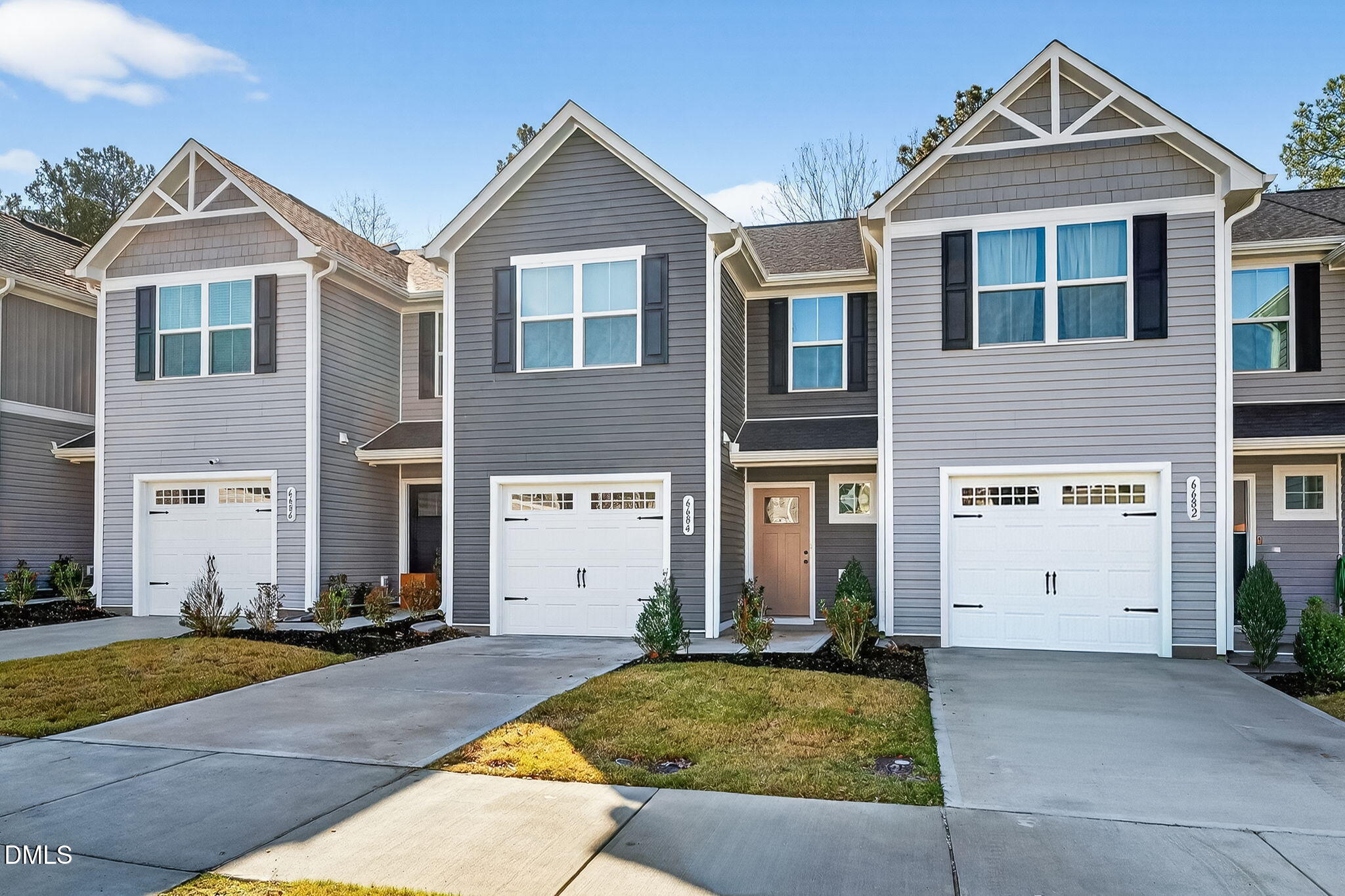 6684 Gibraltar Rock Drive Raleigh, NC 27610 - Photo 4 of 33 a view of a brick house with a yard and large windows