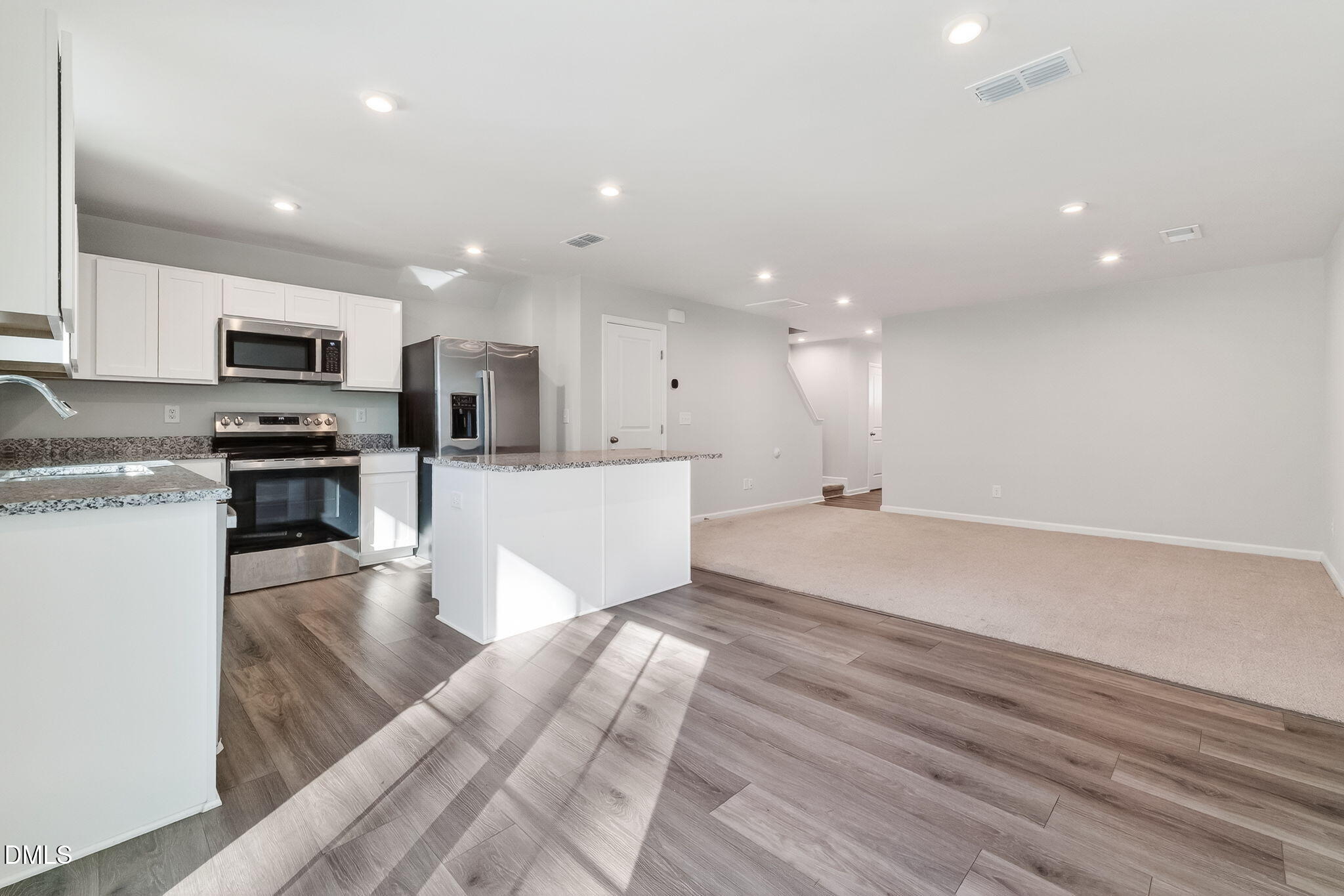 6684 Gibraltar Rock Drive Raleigh, NC 27610 - Photo 7 of 33 a view of kitchen with microwave a stove and wooden cabinets