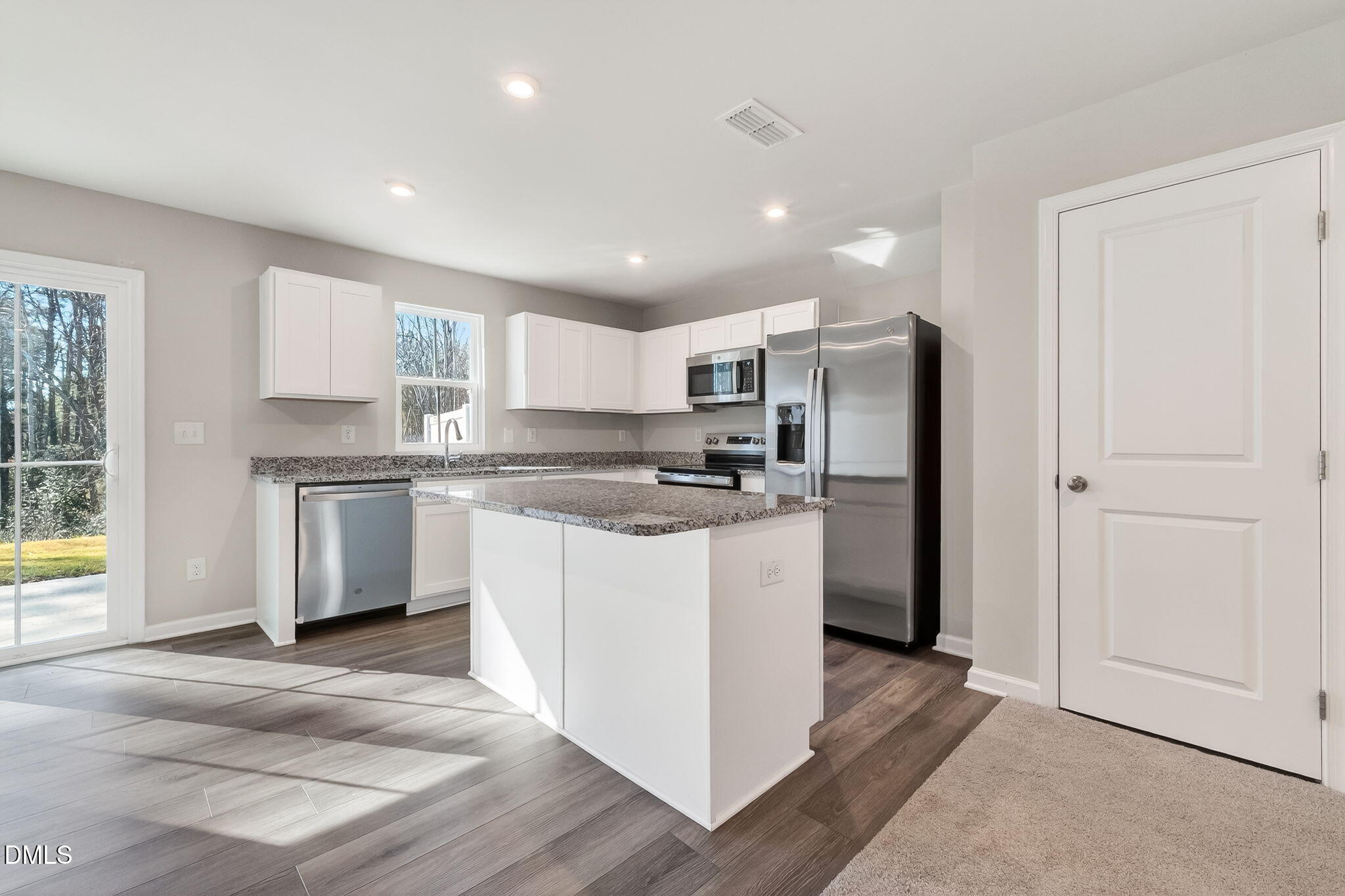 6684 Gibraltar Rock Drive Raleigh, NC 27610 - Photo 9 of 33 a kitchen with stainless steel appliances granite countertop a refrigerator and a stove top oven