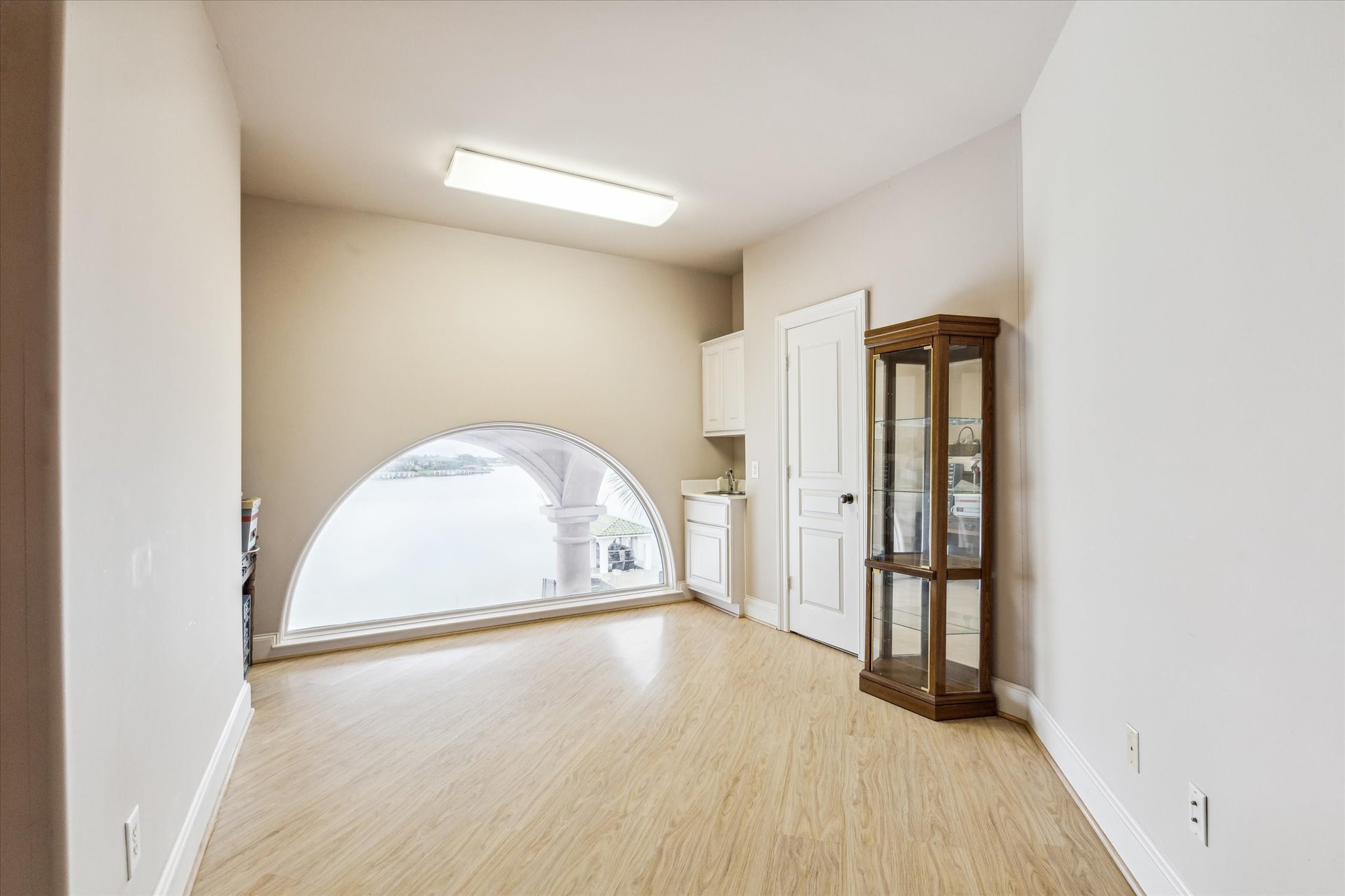 1818 Ray Shell Court Seabrook, TX 77586 - Photo 34 of 50 an empty room with wooden floor and a window