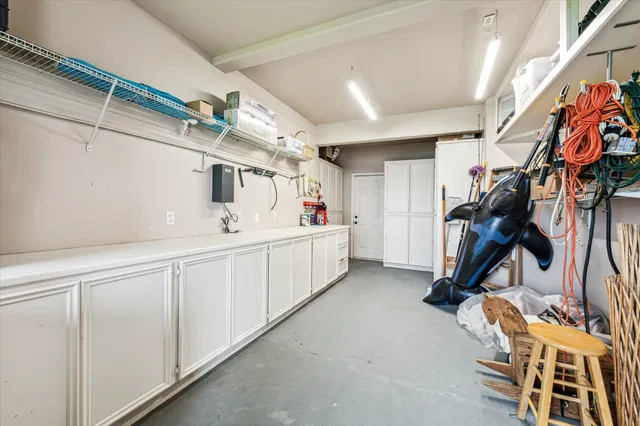 a front view of a house with garden and trees