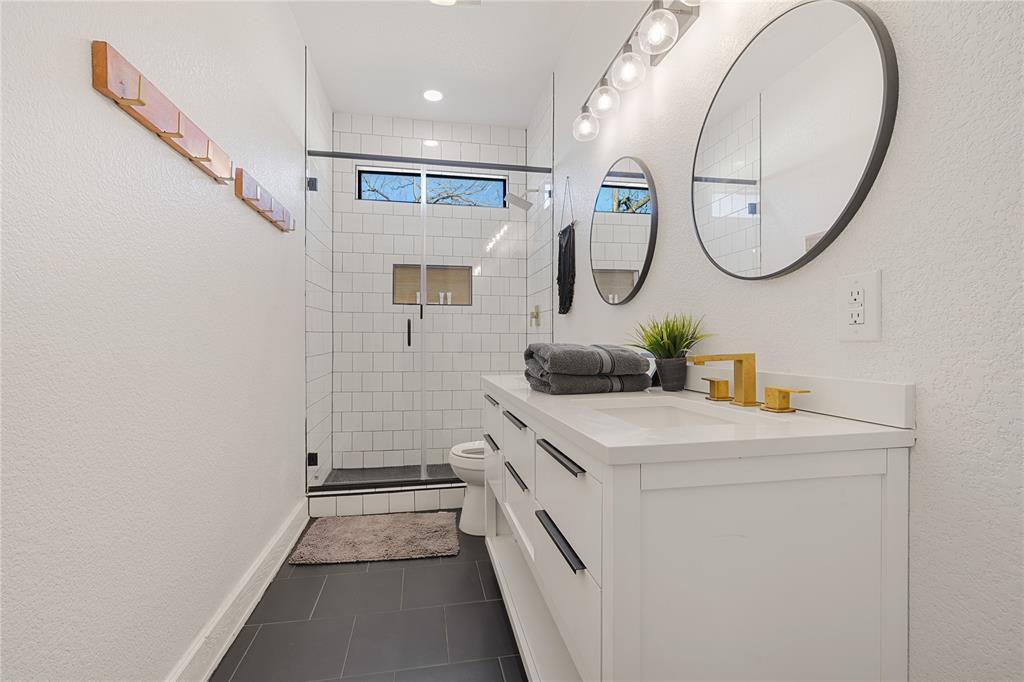 1782 Fm 2951, Unit 2 Graford, TX 76449 - Photo 12 of 21 a bathroom with a sink a mirror and a shower