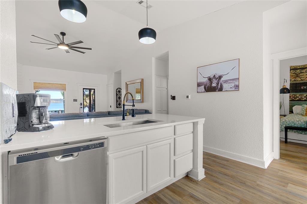1782 Fm 2951, Unit 2 Graford, TX 76449 - Photo 5 of 21 a kitchen with a sink cabinets and wooden floor