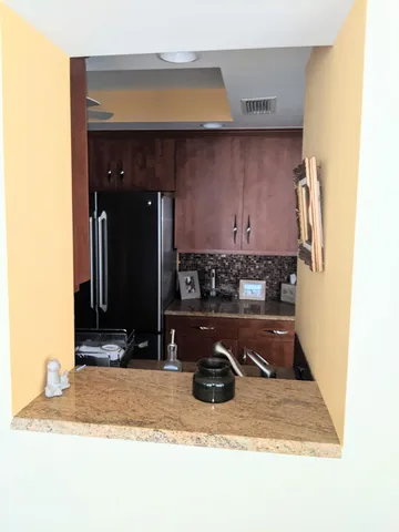 a kitchen with a refrigerator and a sink