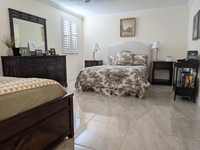 a bedroom with a bed and a flat screen television