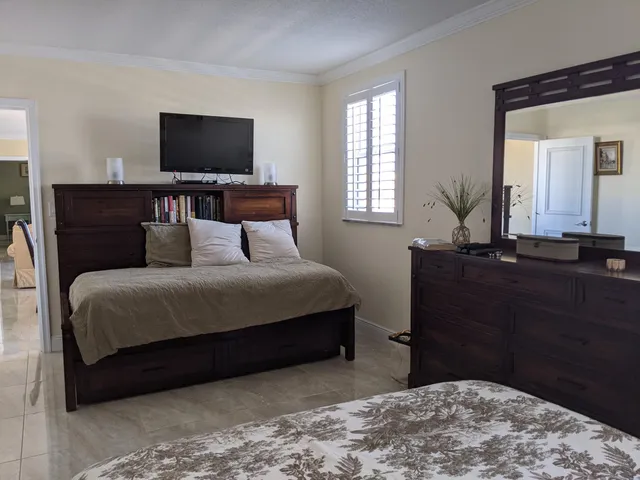 a bedroom with a bed and a flat screen tv