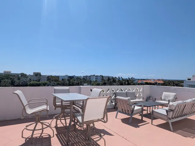 a view of a balcony with furniture