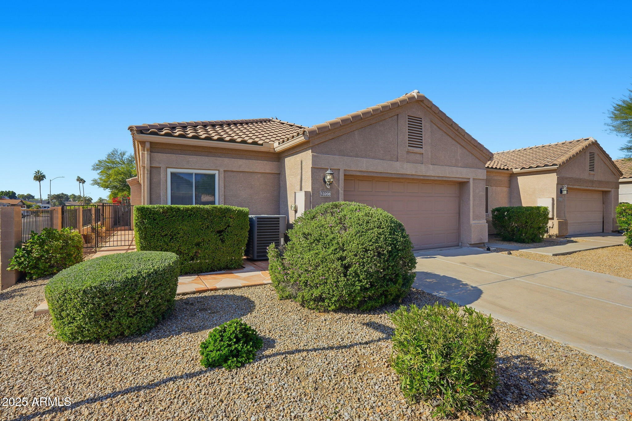 a view of a house with a small yard and plants