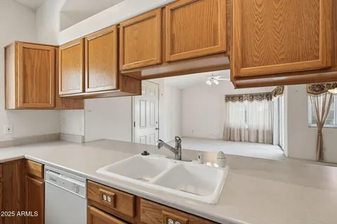 a kitchen with stainless steel appliances granite countertop a sink and a white cabinets