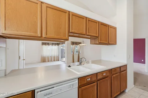 a kitchen with stainless steel appliances granite countertop a refrigerator microwave and sink