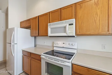 a view of a balcony with wooden floor and fence