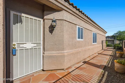 an empty room with chandelier fan
