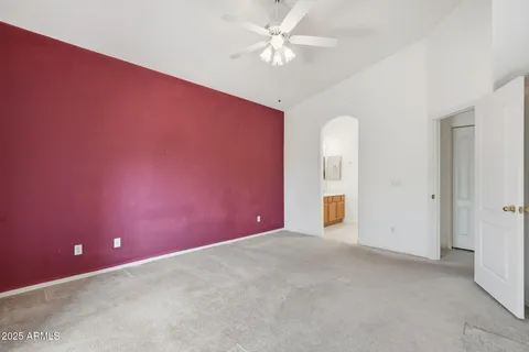 an empty room with a ceiling fan and a window