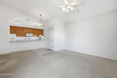 a view of a chandelier in big room and chandelier fan