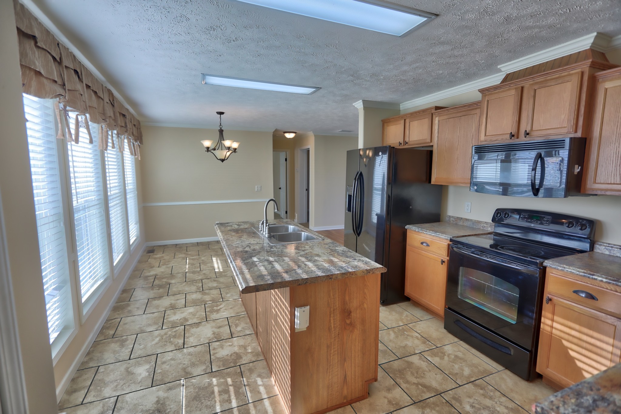 7438 Chowning Road Springfield, TN 37172 - Photo 19 of 33 a kitchen with stainless steel appliances granite countertop a stove refrigerator and cabinets