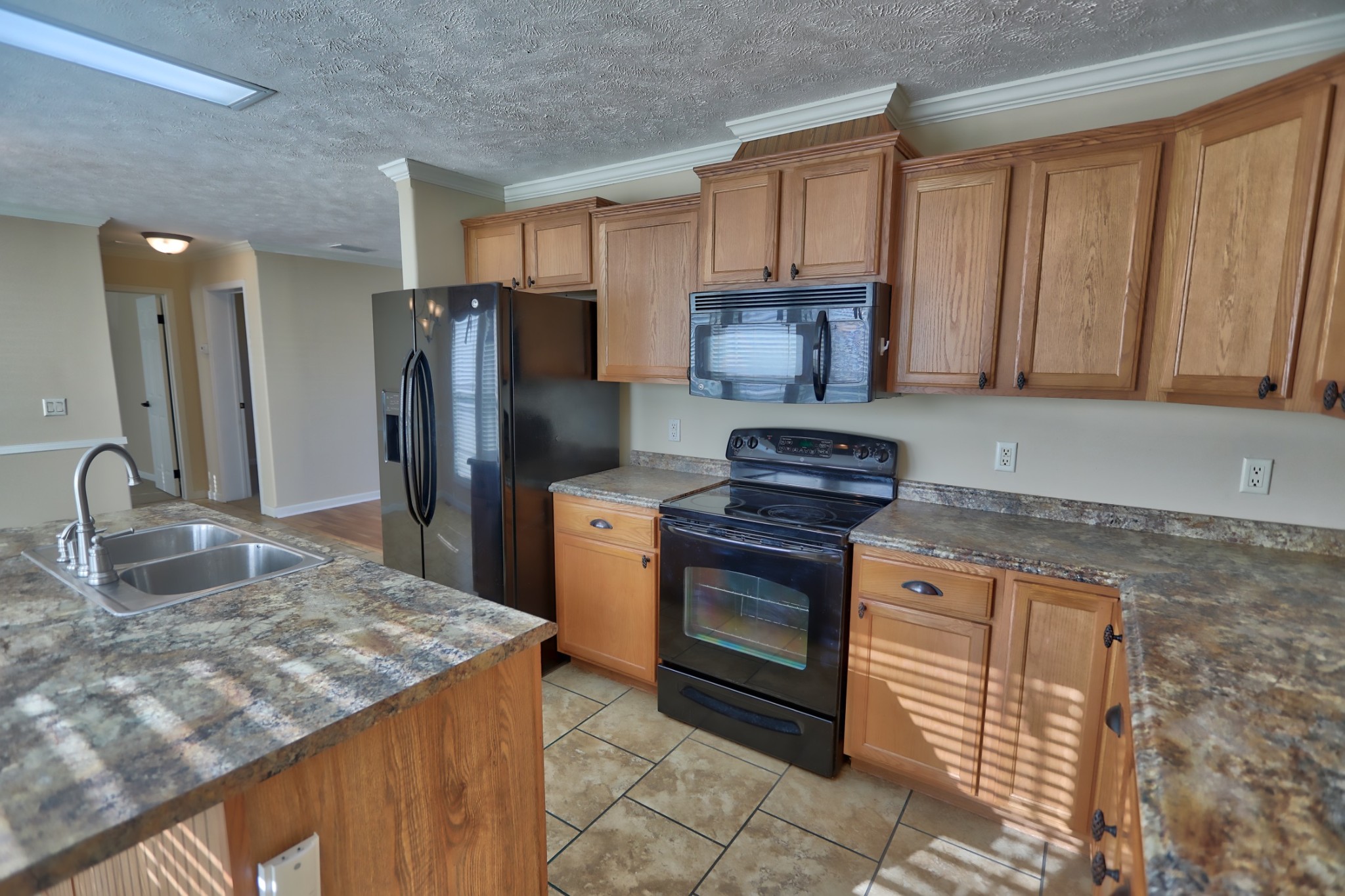 7438 Chowning Road Springfield, TN 37172 - Photo 20 of 33 a kitchen with stainless steel appliances granite countertop a stove a sink and a microwave