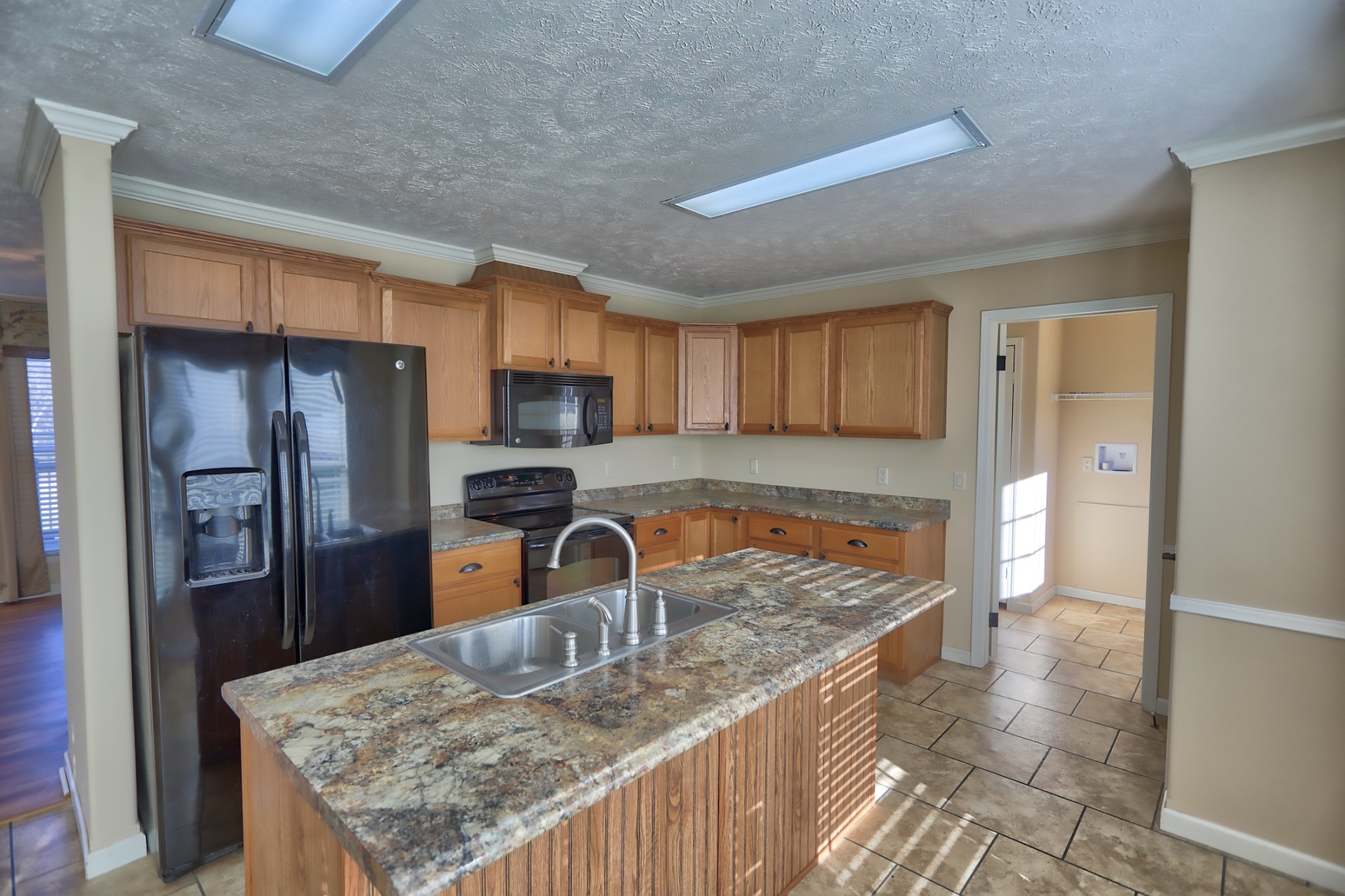 7438 Chowning Road Springfield, TN 37172 - Photo 2 of 33 a kitchen with stainless steel appliances granite countertop a sink refrigerator and microwave