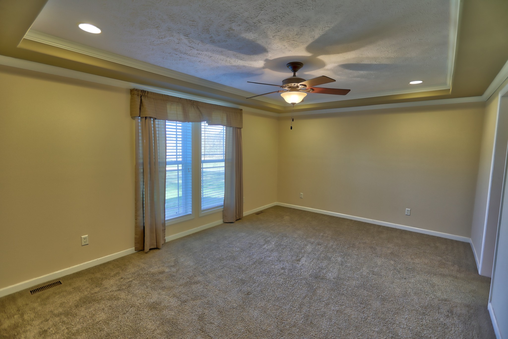 7438 Chowning Road Springfield, TN 37172 - Photo 22 of 33 an empty room with a chandelier fan and windows