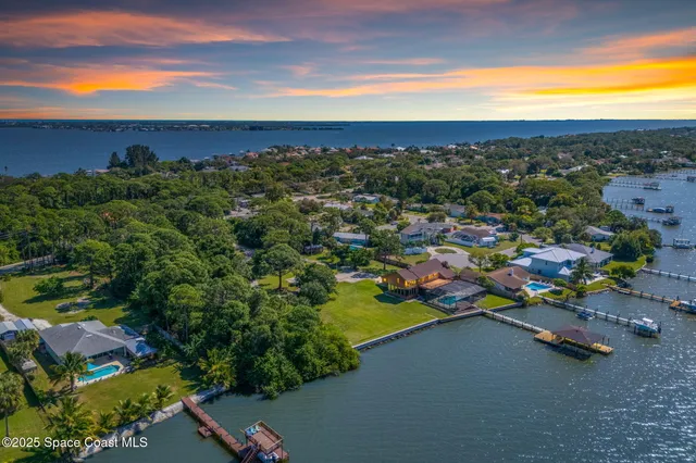 an aerial view of a houses with a yard