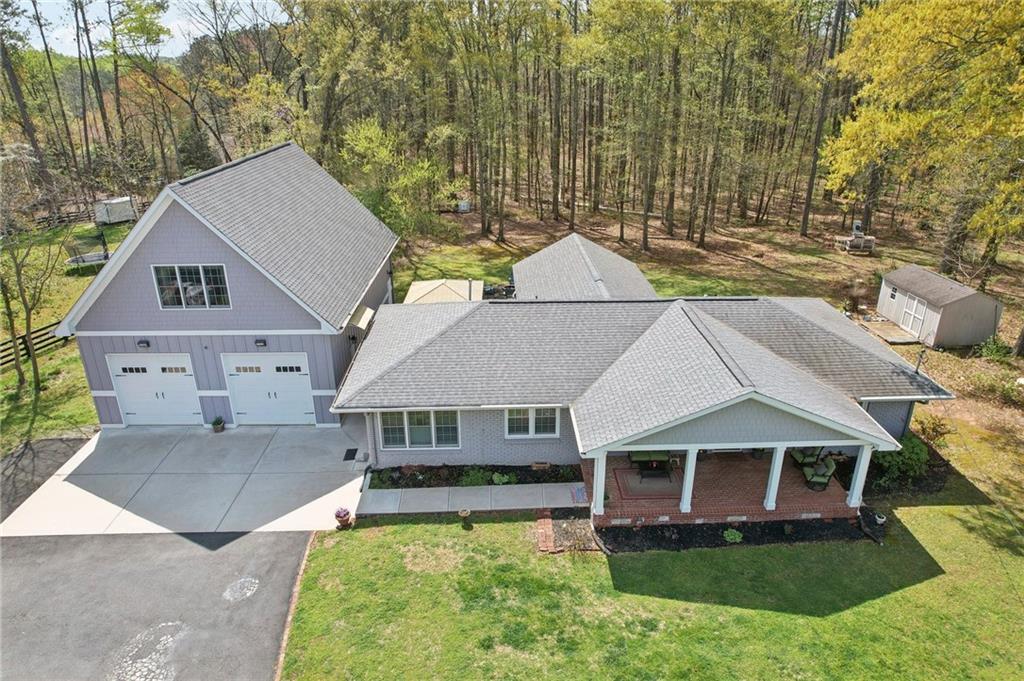 15425 South Thompson Road Milton, GA 30004 - Photo 1 of 1 a aerial view of a house with swimming pool next to a yard