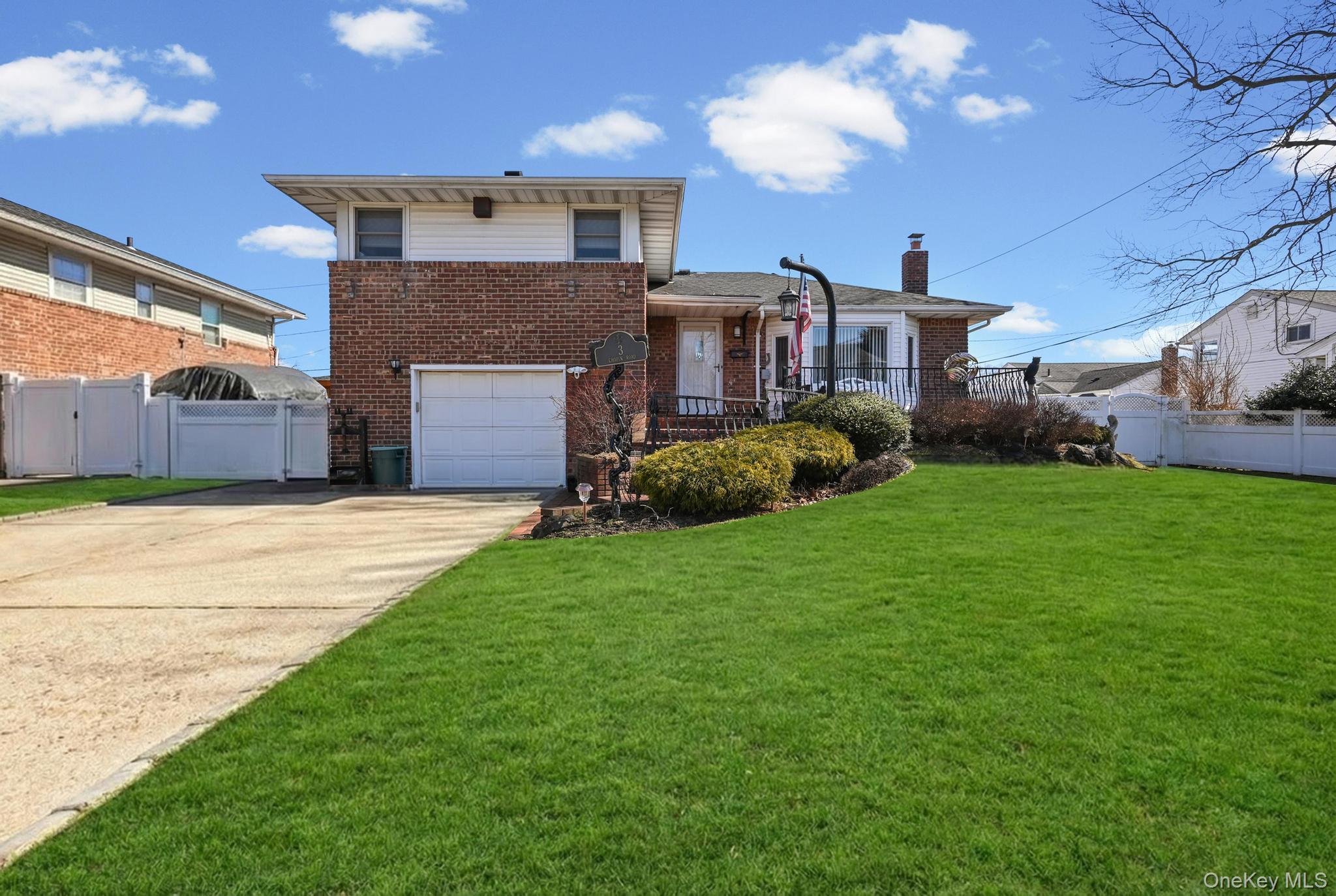 3 Chapin Road Farmingdale, NY 11735 - Photo 1 of 26 a front view of a house with a yard and garage