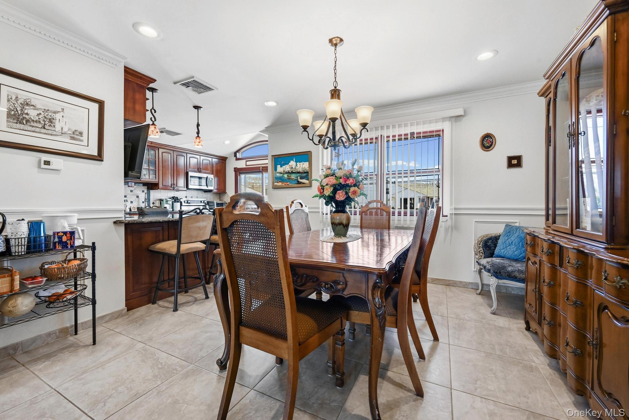 3 Chapin Road Farmingdale, NY 11735 - Photo 11 of 26 a view of a dining room and livingroom with furniture wooden floor a rug a painting and a chandelier