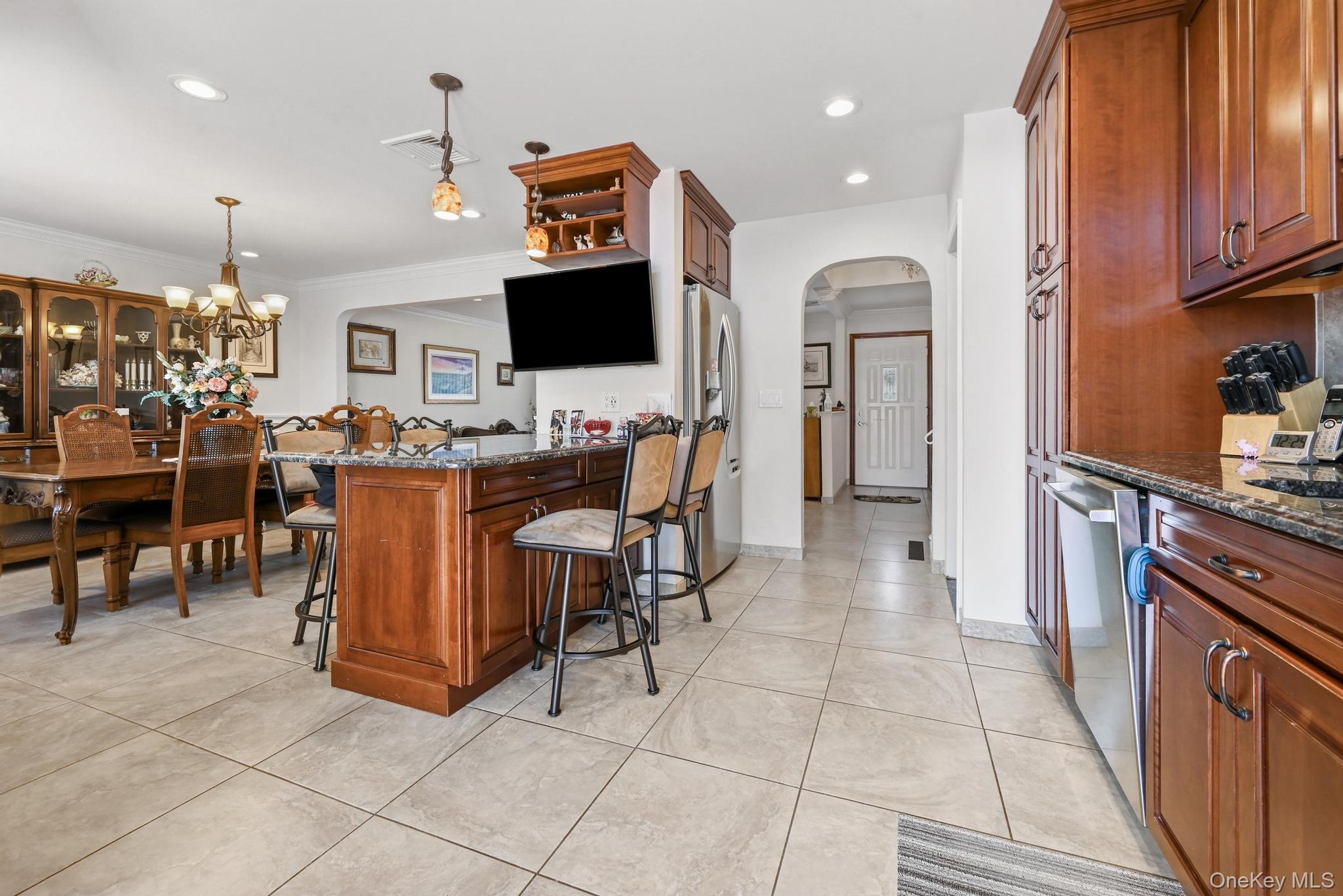 3 Chapin Road Farmingdale, NY 11735 - Photo 12 of 26 a view of a kitchen with kitchen island stainless steel appliances refrigerator stove microwave and cabinets