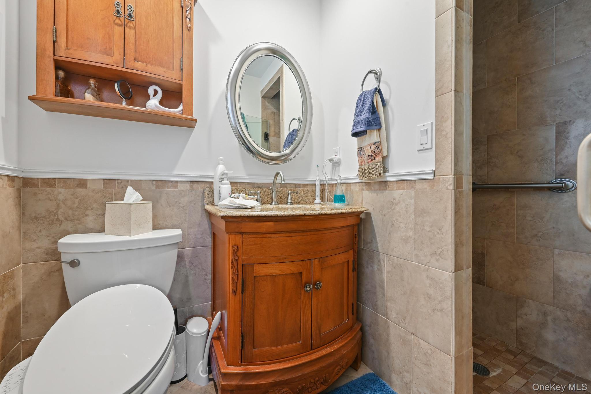 3 Chapin Road Farmingdale, NY 11735 - Photo 16 of 26 a bathroom with a toilet mirror and vanity