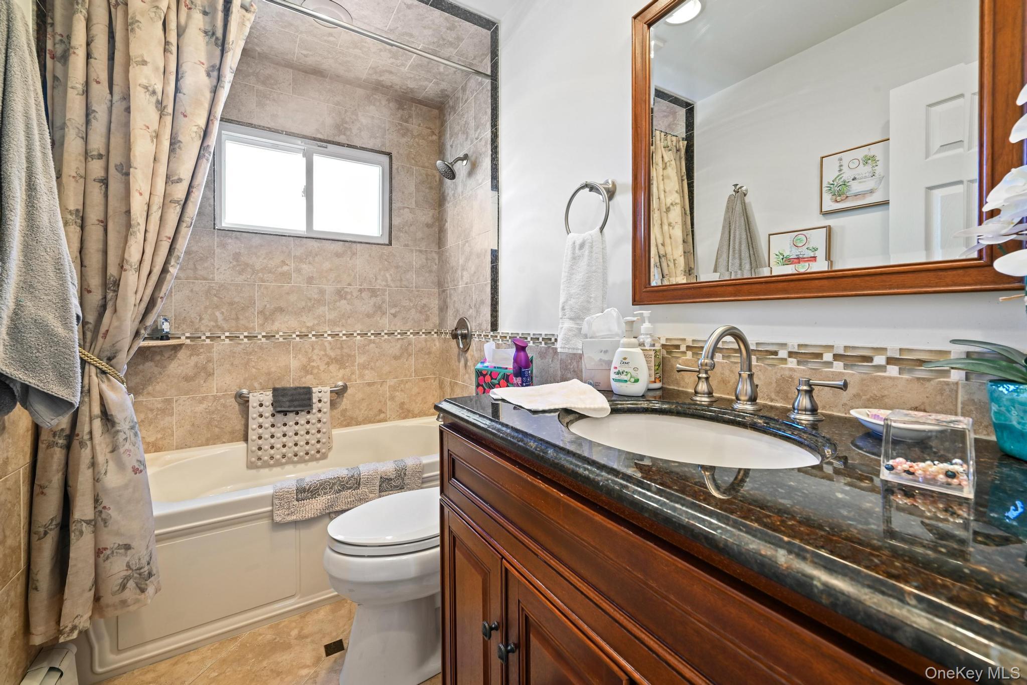3 Chapin Road Farmingdale, NY 11735 - Photo 19 of 26 a bathroom with a granite countertop toilet a sink and a mirror