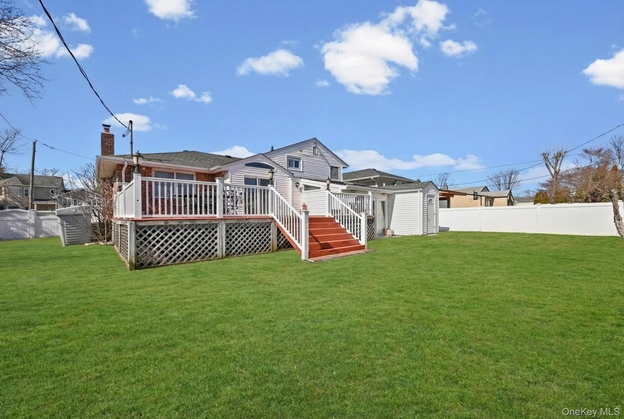 3 Chapin Road Farmingdale, NY 11735 - Photo 2 of 26 a view of a house with a big yard and large trees