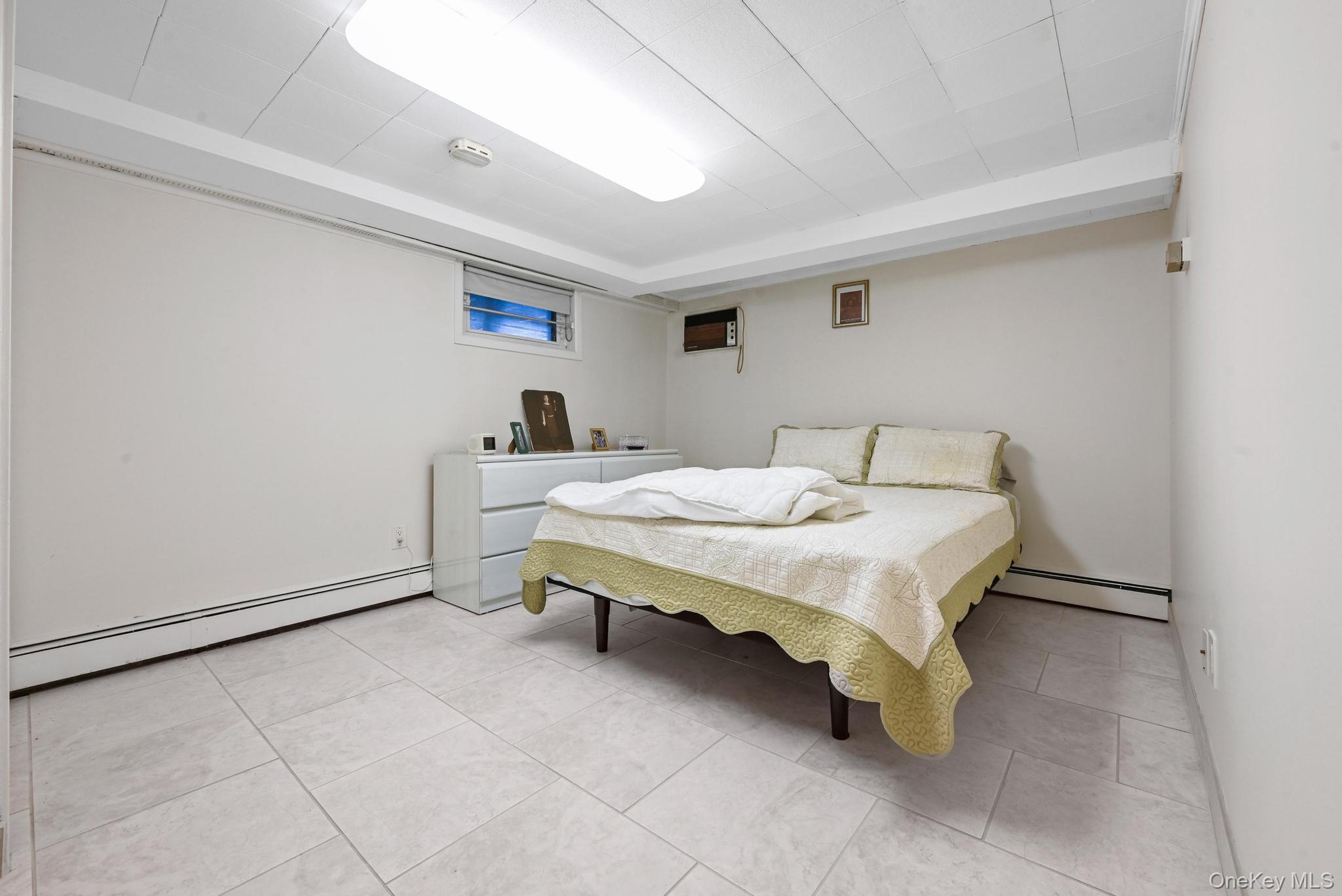 3 Chapin Road Farmingdale, NY 11735 - Photo 22 of 26 a bedroom with a bed and lamp