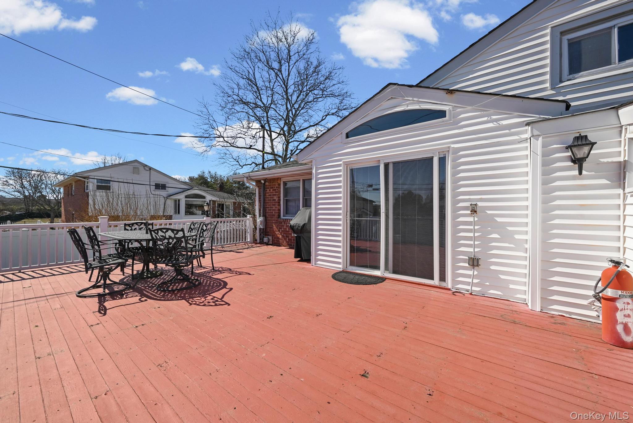 3 Chapin Road Farmingdale, NY 11735 - Photo 6 of 26 a view of a patio with table and chairs with wooden floor and fence