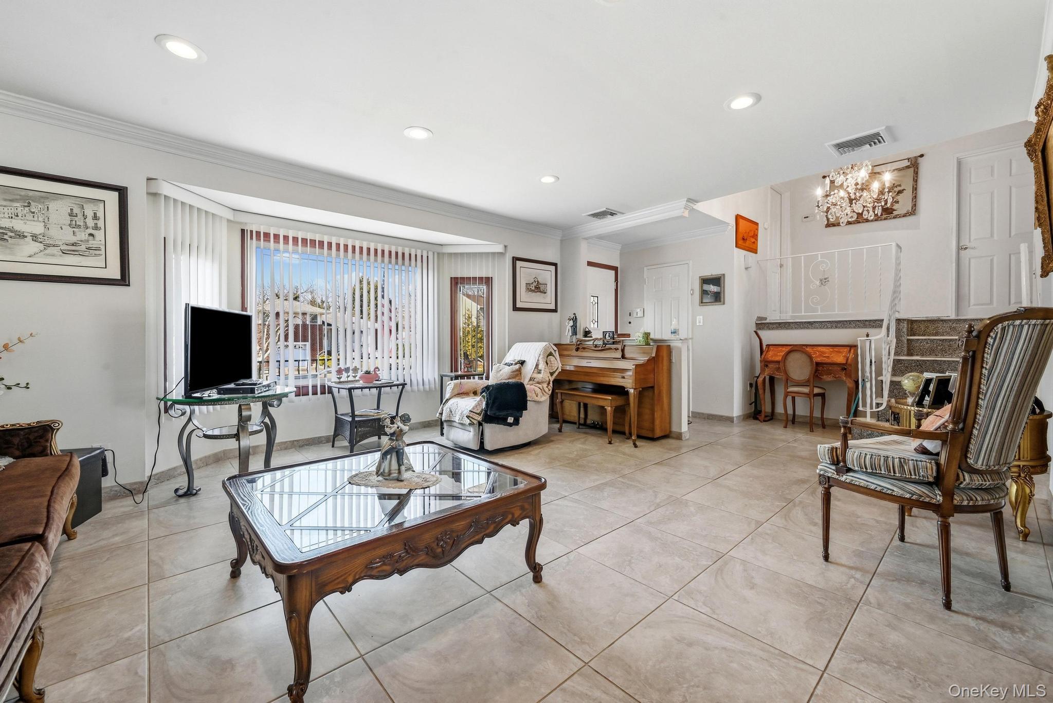 3 Chapin Road Farmingdale, NY 11735 - Photo 9 of 26 a living room with furniture a flat screen tv and a fireplace