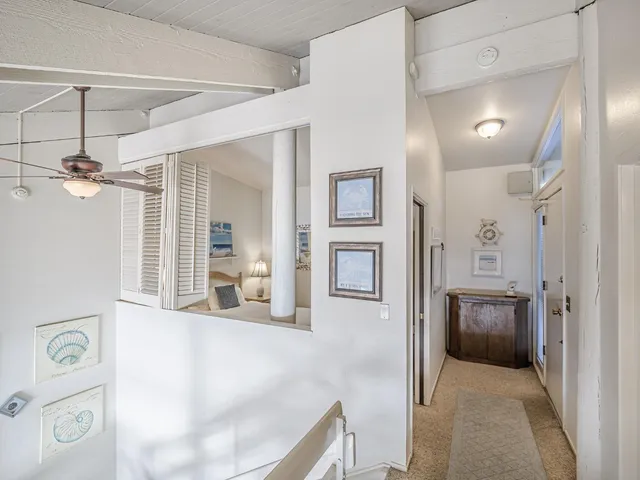 a bedroom with a bed and a night stand