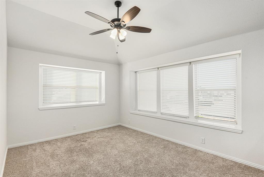 303 Pineview Lane Ponder, TX 76259 - Photo 14 of 19 an empty room with chandelier fan and windows