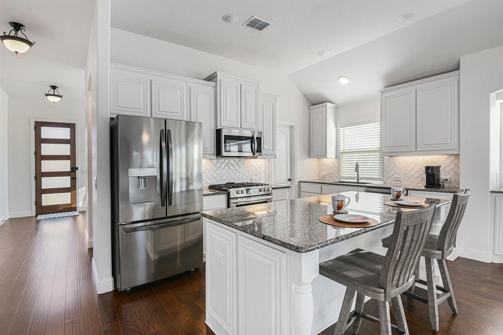 303 Pineview Lane Ponder, TX 76259 - Photo 5 of 19 a kitchen with refrigerator a stove a sink and a refrigerator