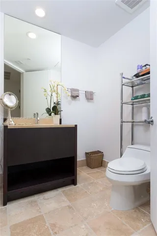 a bathroom with a sink toilet and a mirror
