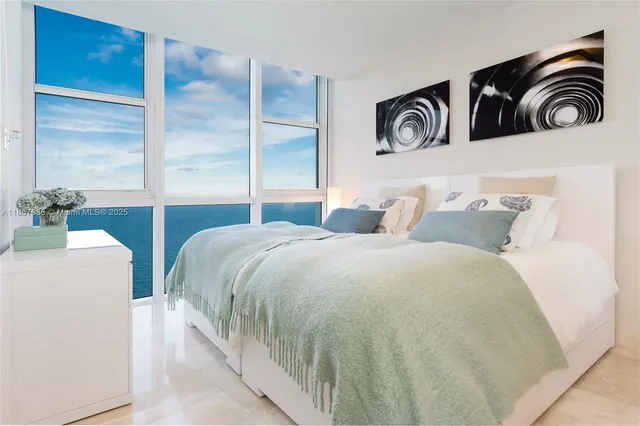 a bedroom with two beds and a window