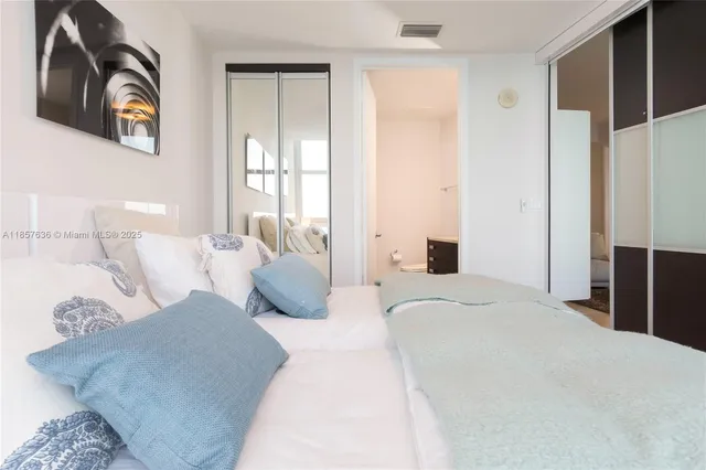 a bedroom with a large bed and a couch