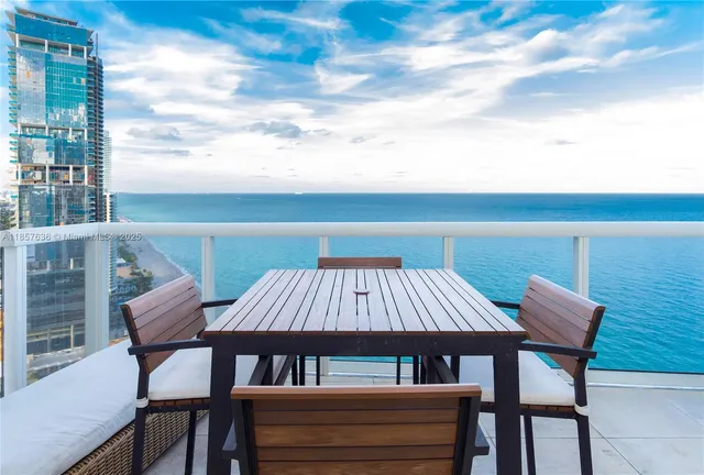 a view of a patio with a table and chairs