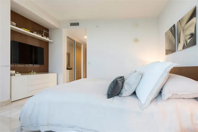 a spacious bedroom with a bed and a couch