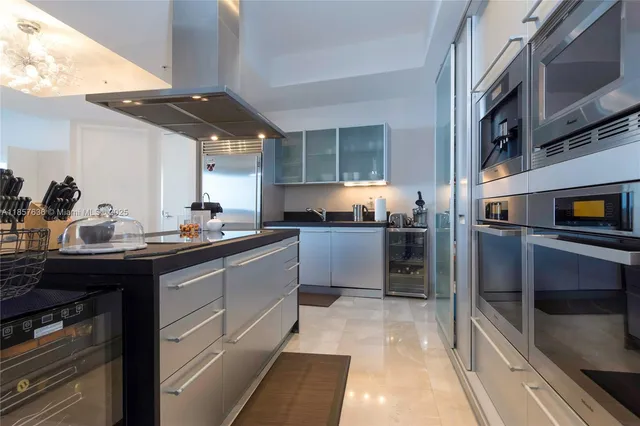 a kitchen with stainless steel appliances granite countertop a sink and a stove